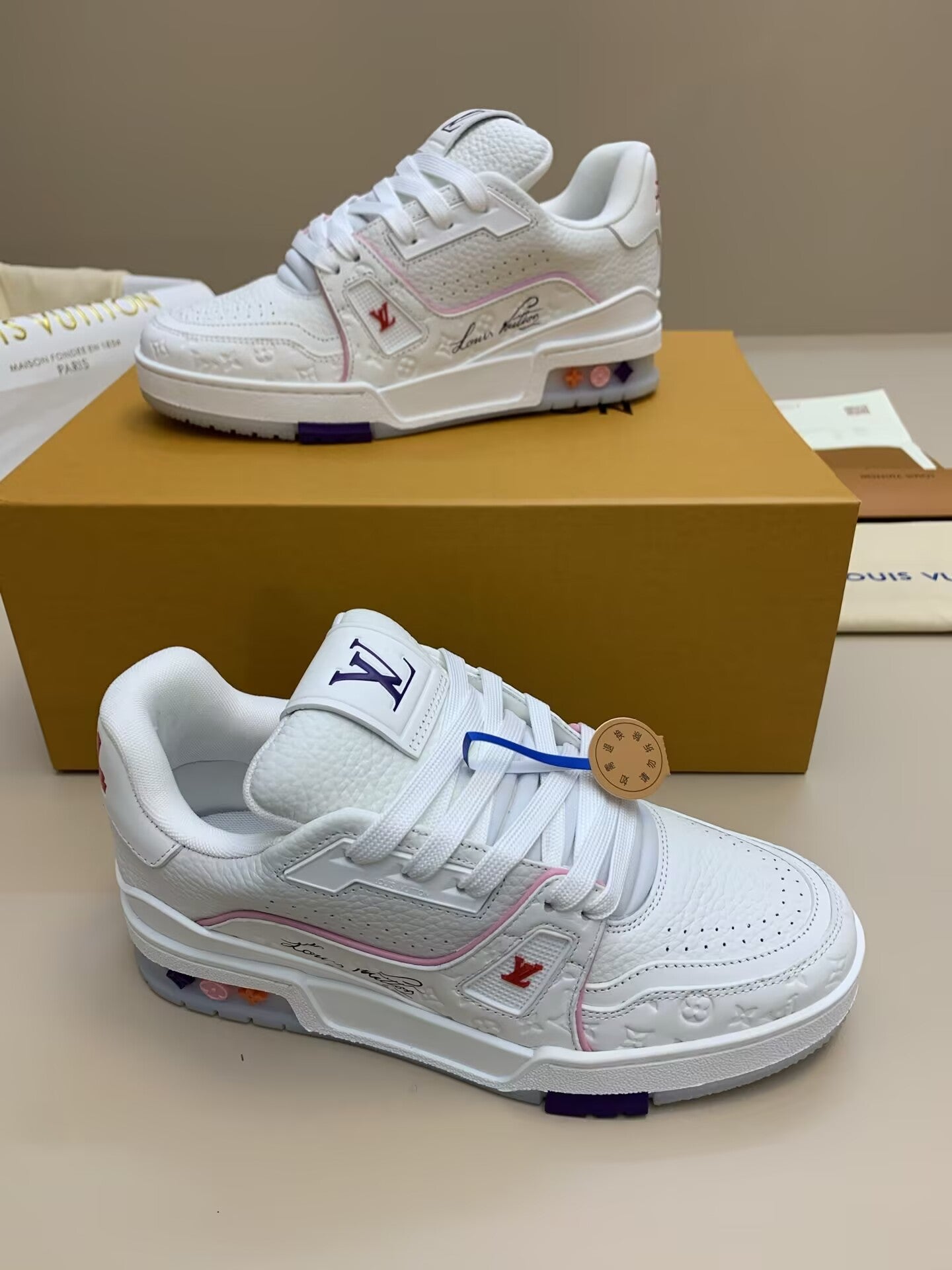 White sneaker with patterned upper and colorful sole