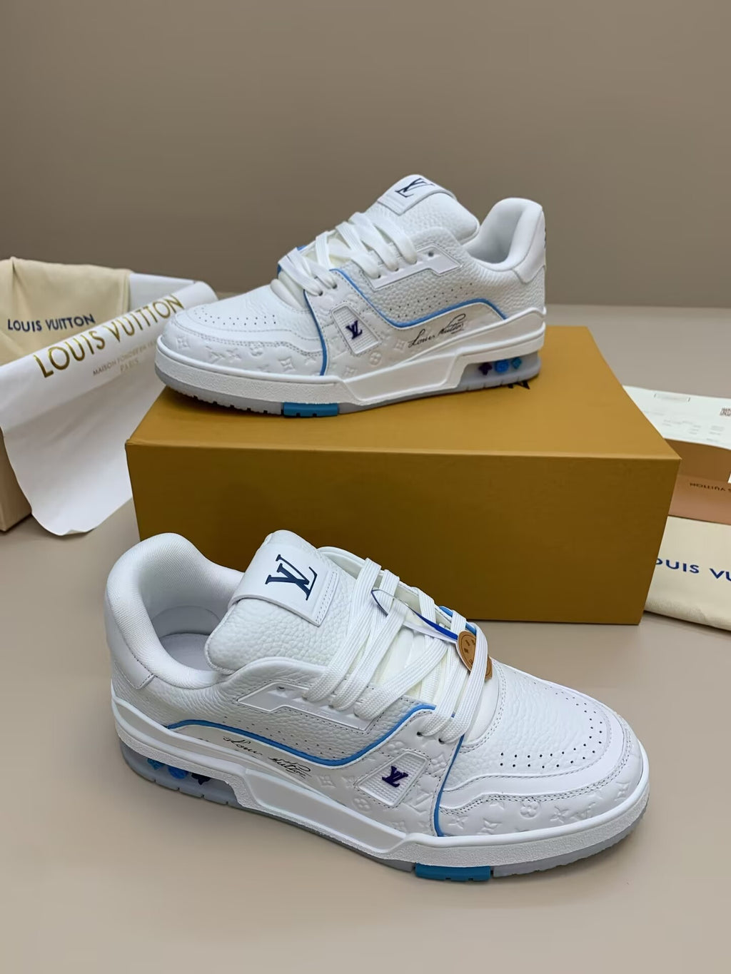 White low-top sneakers with blue trim
