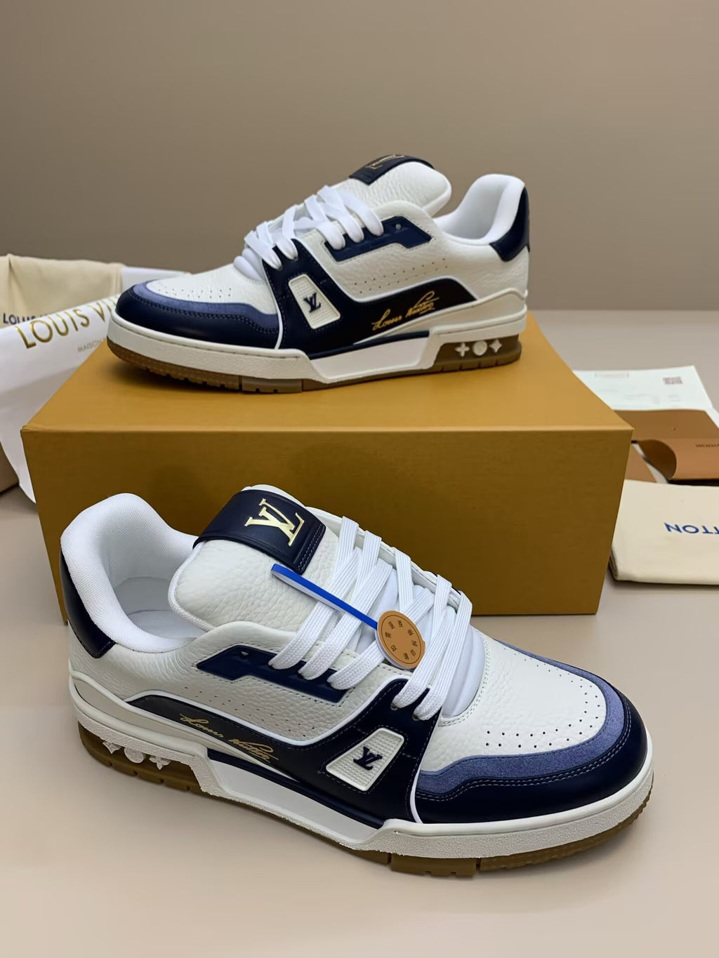 White and navy blue leather sneakers with patterned upper