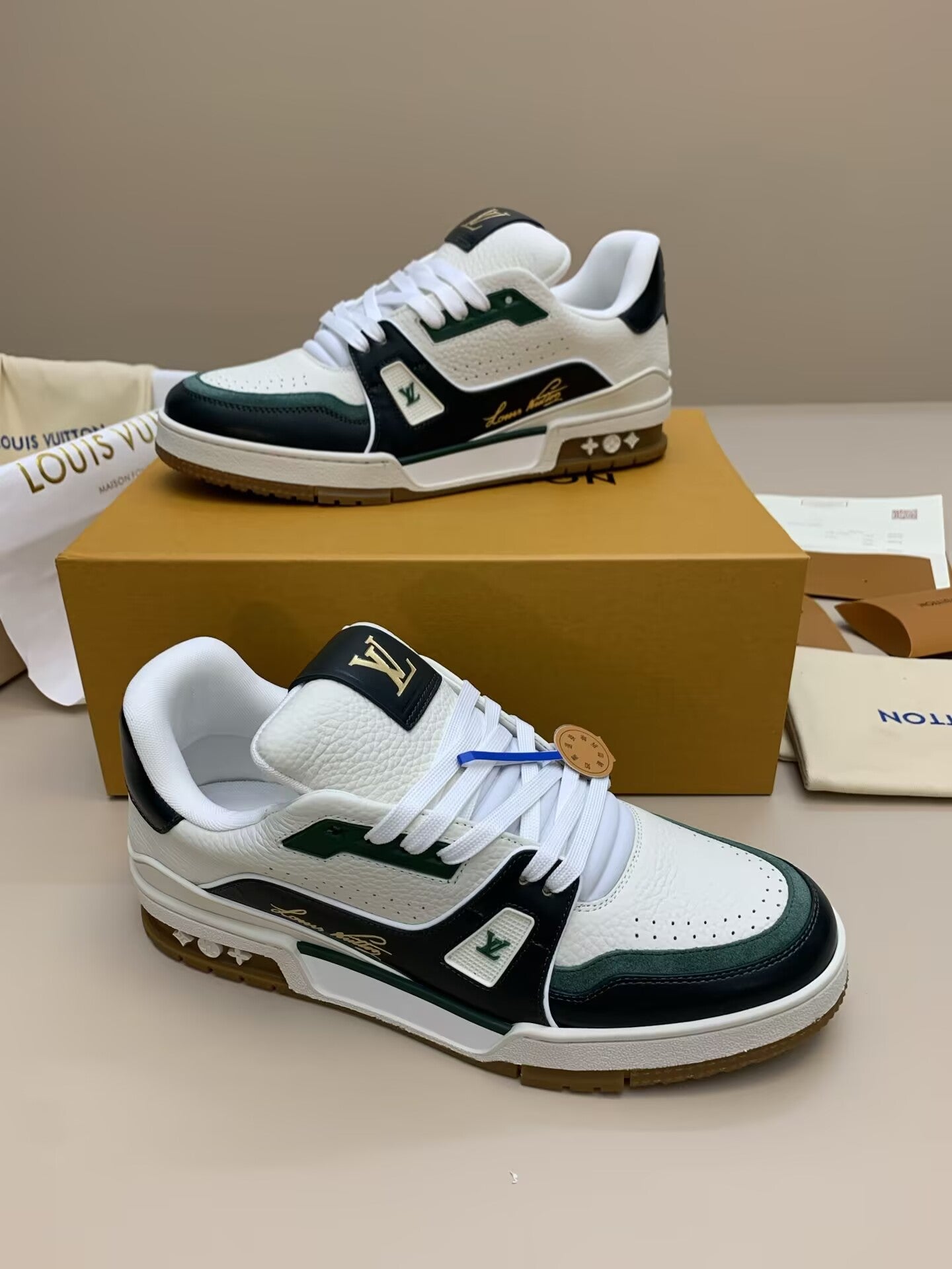 White and black leather sneakers with green accents