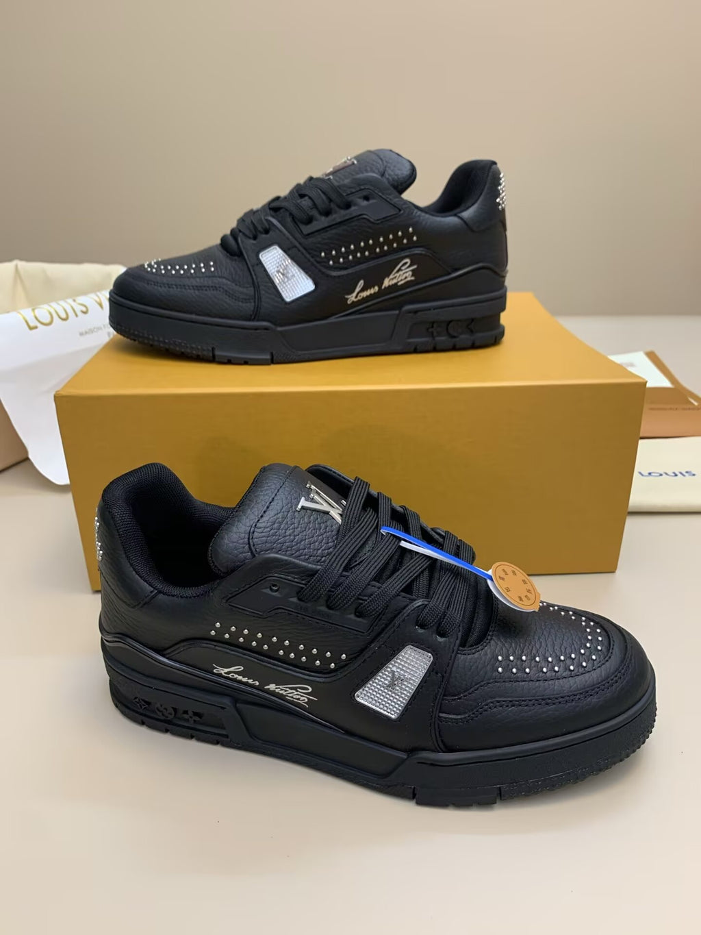 Black leather sneakers with studded detailing